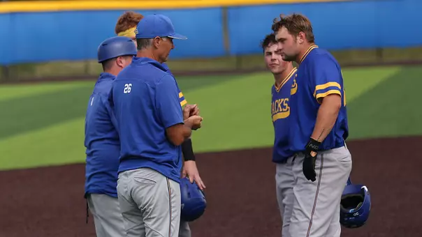 South Dakota State baseball coaches, including head coach Rob Bishop, and players Owen Siegert and Dayton Franke discuss strategy during an exhibition game in the fall of 2025.