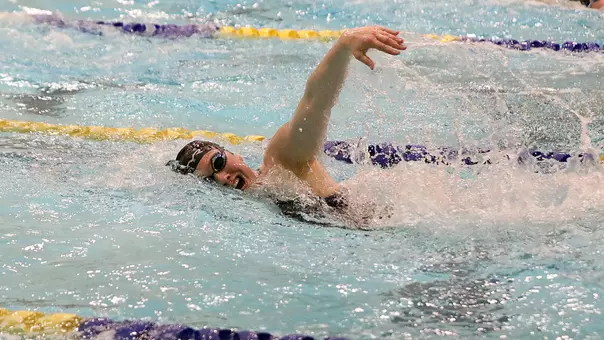Jenna Currier swims freestyle in home action.