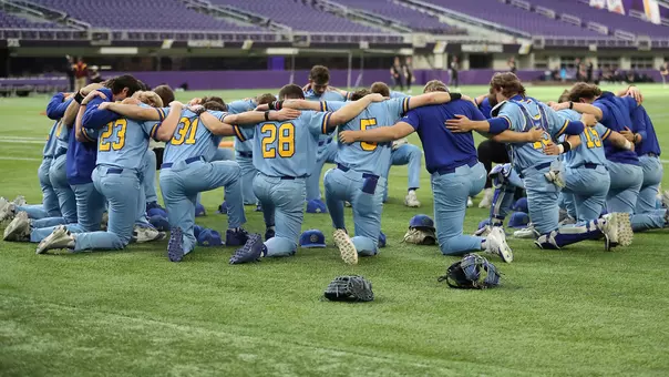 South Dakota State baseball players huddle for a pregame prayer prior to their March 8, 2026, game against Southern Illinois as part of the Cambria Classic played at U.S. Bank Stadium in Minneapolis, Minnesota.