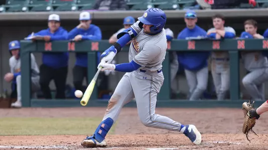 South Dakota State first baseman/designated hitter Dayton Franke makes solid contact while batting against Nebraska in action March 4, 2026. Franke is pictured swinging a yellow bat while wearing a gray uniform and blue batting helmet.
