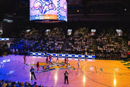 A women's basketball team gets ready for tip off.
