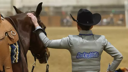 A South Dakota State equestrian Western rider and horse wait for their turn in the competition ring during action against Delaware State in February 2026 at the DeHaan Equestrian Center in Brookings, South Dakota.
