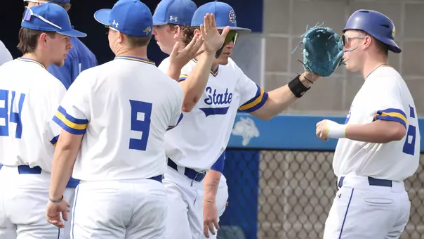 South Dakota State shortstop Keagen Jirschele high-fives teammates during pre-game introductions at the Jackrabbits' March 20 home opener against North Dakota State.