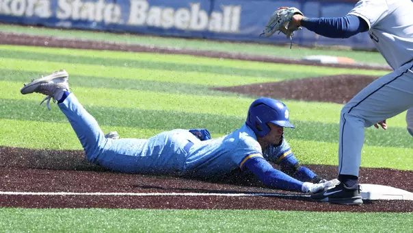 South Dakota State baseball player Keagen Jirschele slides headfirst and safely into third base to complete a triple in action against Oral Roberts on April 19, 2026, at Erv Huether Field in Brookings, South Dakota.