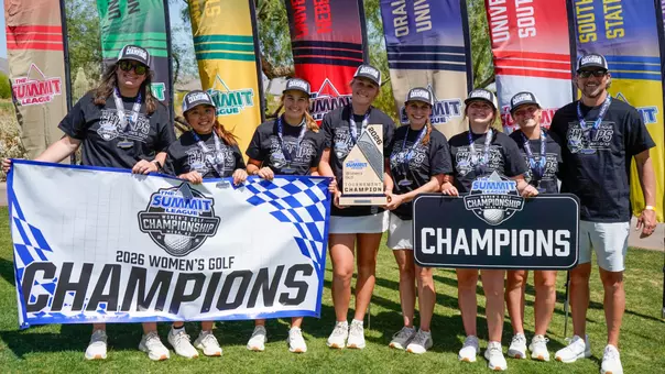 The South Dakota State women's golf team, wearing black championship t-shirts and hats, pose for a photo during the awards ceremony at the Summit League Championships