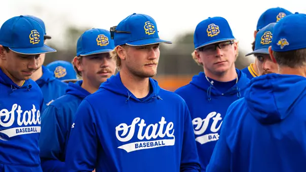 South Dakota State baseball players gather for a postgame talk by head coach Rob Bishop following an April 14 victory against Midland at Er Huether Field in Brookings, South Dakota.