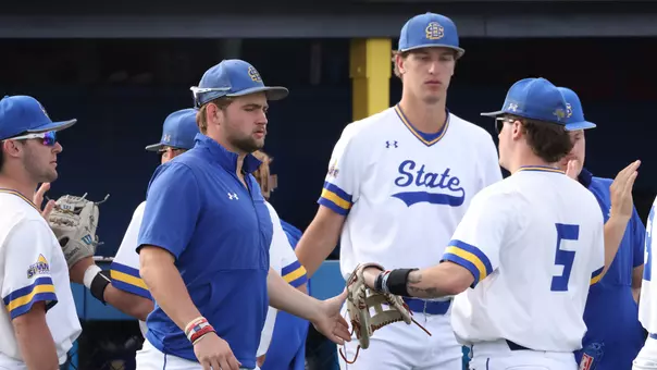 South Dakota State players (from left) Brady Brown, Dayton Franke and Tristan Augedahl congratulate No. 5 Luke Wroblewski on his way back to the dugout during a March 20 game against North Dakota State at Erv Huether Field.
