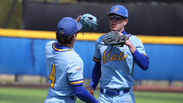 South Dakota State baseball players and infielders Keagen Jirschele (left, #4) and Nolan Grawe tap gloves prior to the start of the Jackrabbits' May 9, 2026, game against St. Thomas at Erv Huether Field in Brookings, South Dakota.
