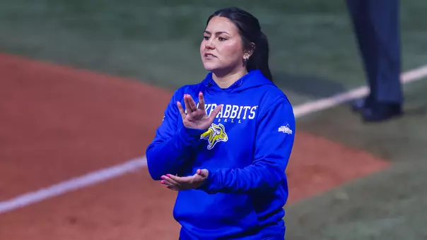 An image of Rozelyn Carrillo in a blue hoodie with Jackrabbits written and a logo as she prepares to talk and claps her hands