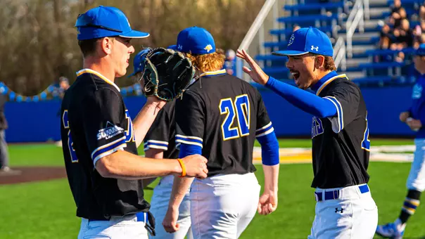 South Dakota State baseball players Nolan Grawe (left) and Will Kent (right) exchange high-fives in front of the Jackrabbit dugout during action against Northern Colorado on April 24, 2026, at Erv Huether Field in Brookings, South Dakota.