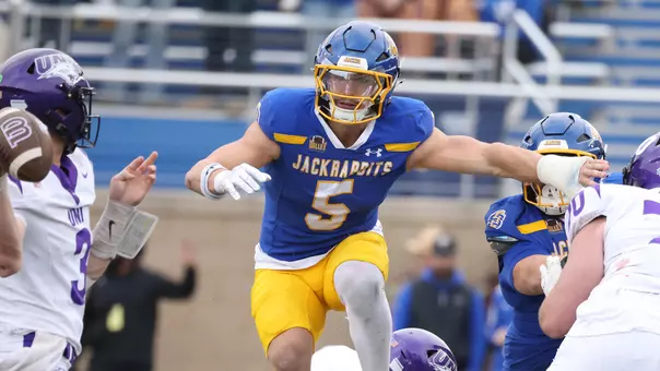 South Dakota State linebacker Cullen McShane leaps over a Northern Iowa defender on his way to pressuring the quarterback in action during the Jackrabbits' Hobo Day victory at Dana J. Dykhouse Stadium on Oct. 11, 2025.