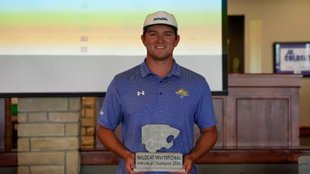 Jake Olson holding the individual tournament champion trophy for the Wildcat Invitational