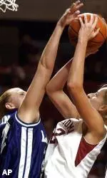 Amy Collins blocks the shot of Oklahoma center Theresa Schuknecht during first half action.
