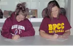 Becca Sustaire (left) and Sabrina Johnston, student-athletes at Bossier Parish Community College, sign national letters of intent to play softball at SFA