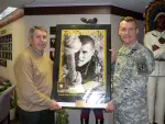 SFA Director of Athletics Robert Hill accepts award from Lt. Col. Jeffrey Pike