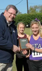 SLC commissioner Tom Burnett presents Lauren Smith with her all-conference plaque after she claimed the SLC individual title.
