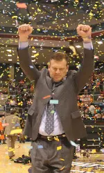 Head Brad Underwood celebrates the 2014 SLC Tournament title as he walks across the court.