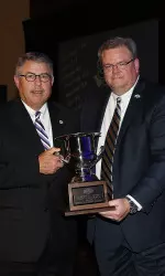 Athletic Director Robert Hill accepts the 2013-14 SLC Women's All-Sport trophy from commissioner Tom Burnett