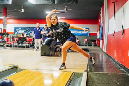 Chloe completing a bowling throw