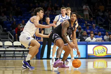 Juhlawnei Stone drives against Drake.