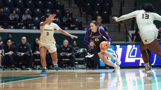 Anika Hyland driving to the basket at SLU