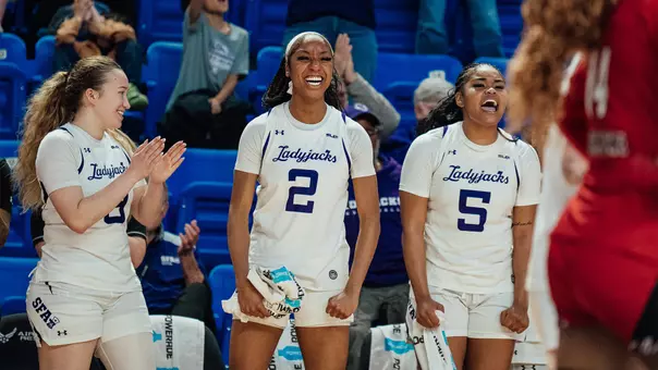 Anika Hyland, Aziyah Farrier, and Key Roseby celebrating on the bench (3-11-26)