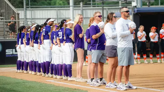 Softball Team on first base line for national anthem
