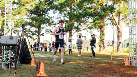 Ryan Binskin crossing the finish line at slc championship