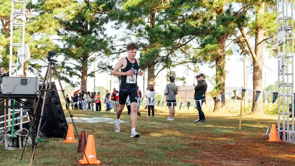 Ryan Binskin crossing the finish line at slc championship