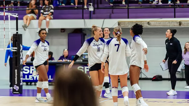 Caroline Kahle celebrating with team after a kill vs Cal (9.5.26)