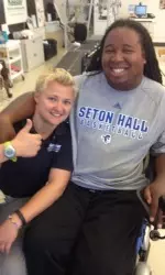 SHU alumna and former women's soccer goalkeeper Sandra "Buffy" Wojciehowski poses with Eric LeGrand