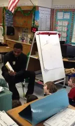 Sterling Gibbs reads to children.