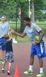 Junior Tiffany Jones gives a high five to a camper from the South Mountain YMCA.