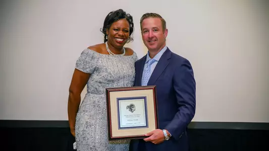 Pat Lyons presents Keisha Caine with Hall of Fame Plaque