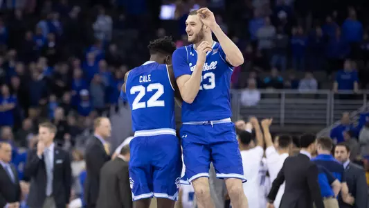 Myles Cale and Sandro Mamukelashvili celebrating at Creighton