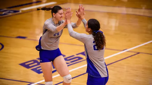 Asli Subasili and Hanna Tulli celebrate after a point on Sept. 23.