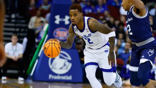 Al-Amir Dawes takes the ball up the floor against Saint Peter's