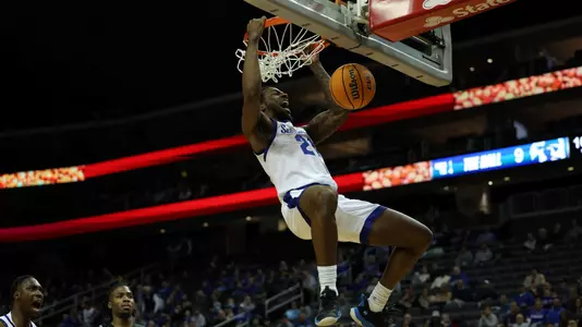 Femi Odukale dunks the ball against Wagner