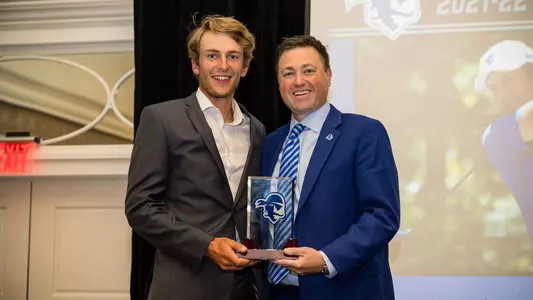 Gregor Tait accepts the Senior Male Athlete of the Year Award from AD Bryan Felt.