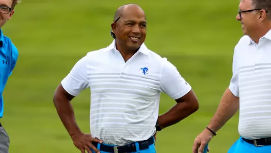Clay White chats with assistant coaches and players prior to the start of a tournament.