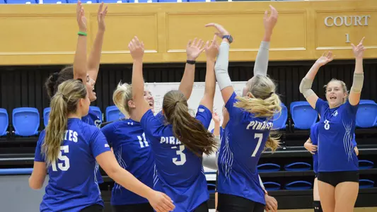 The Seton Hall volleyball team celebrates after the set-winning point during an intra-squad scrimmage.