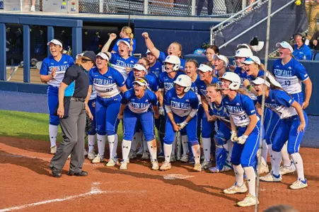 Softball Team Celebrating at Home Plate