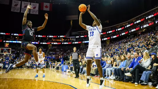 Jaquan Sanders shoots a three-pointer against UConn
