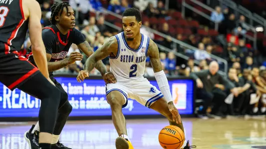 Al-Amir Dawes dribbles in the lane against Northeastern