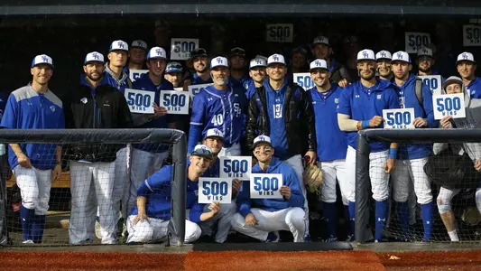 Seton Hall poses in the dugout after Rob Sheppard collected his 500th coaching win.