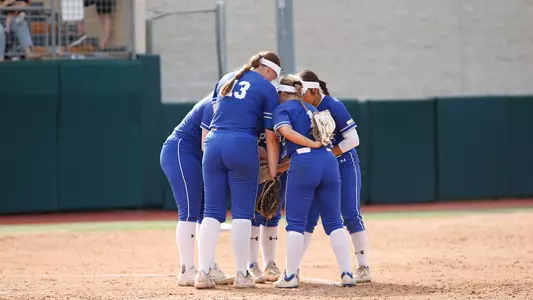 Team Huddle in circle during NCAA Tourney Game vs Texas