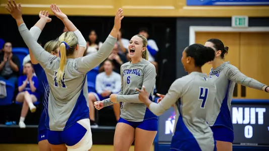 Madeline Matheny celebrates with her team after a point against NJIT on Aug. 31.