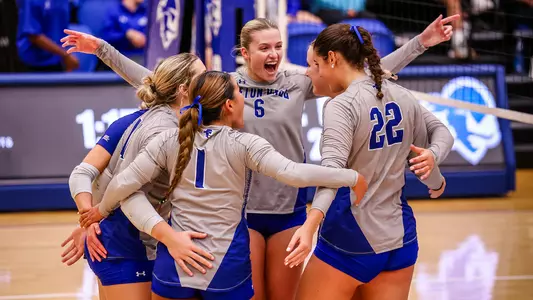 Madeline Matheny and her teammates celebrate after scoring a point against Providence on Sept. 22.