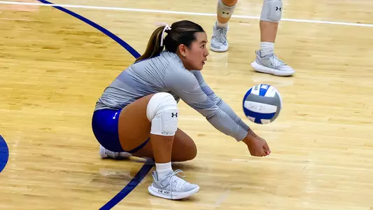 Mason Woo digs the volleyball against Sacred Heart on Sept. 6.