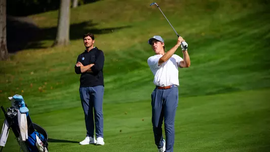 Will Hennessee takes a shot with head coach JT Harper looking on during a practice round in the fall of 2024.